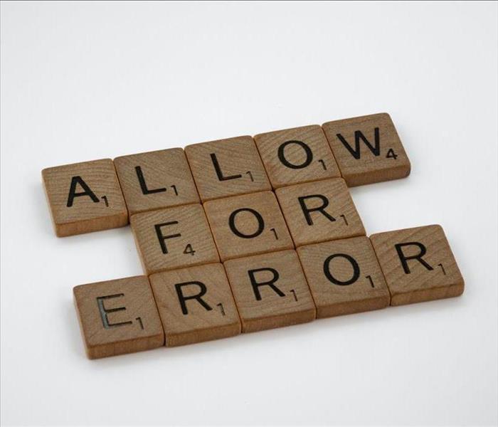 Letters out on a table spelling "allow for error"